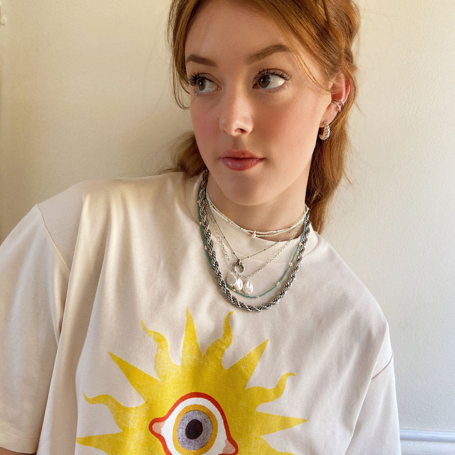 silver jewellery worn with sun print t-shirt