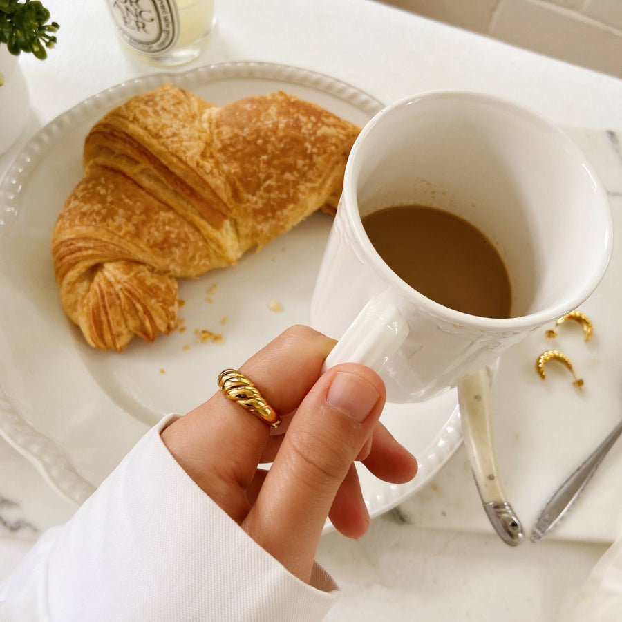 croissant with coffee and gold ring