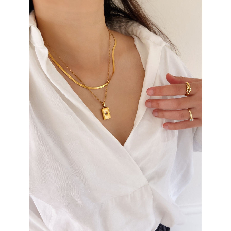 white shirt with gold layering jewellery