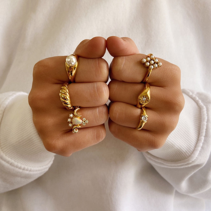 gold gemstone rings stacked on hand