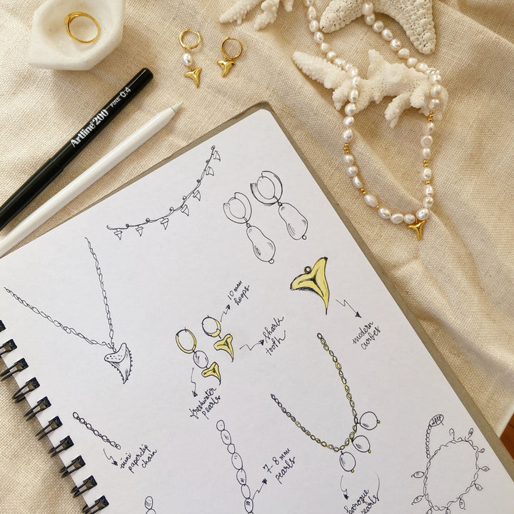 design sketch of shark tooth pearl necklace and ear hoops