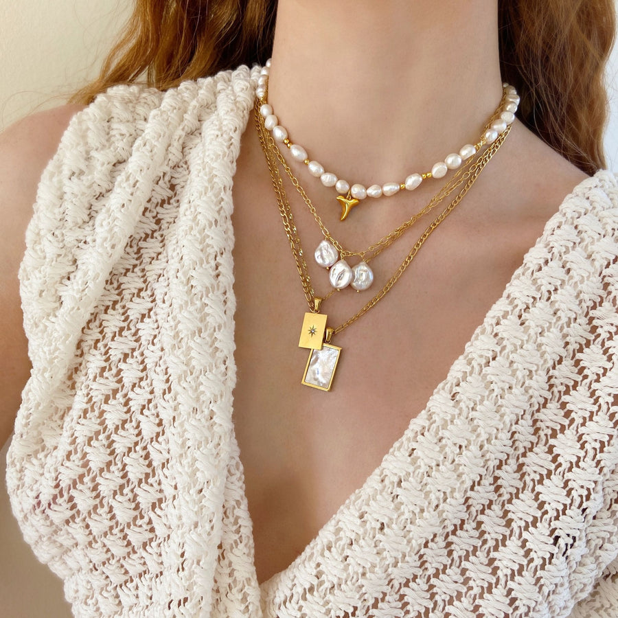 woman wearing pearl necklace stack in cream and gold