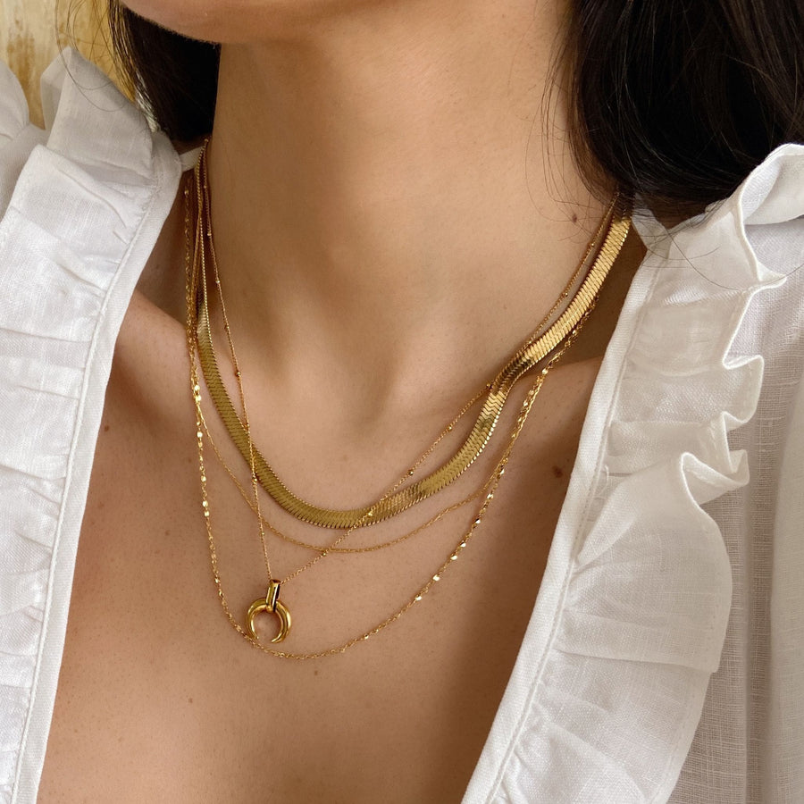 horn necklace with flat snake chain stack in gold