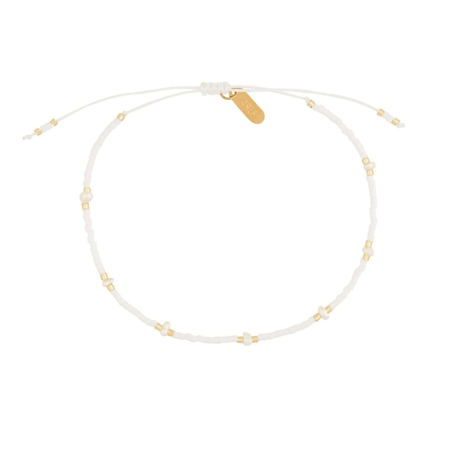 white beaded bracelet in gold with pearls