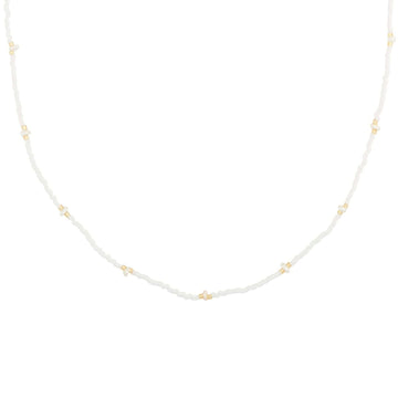 white beaded necklace in gold with tiny pearls