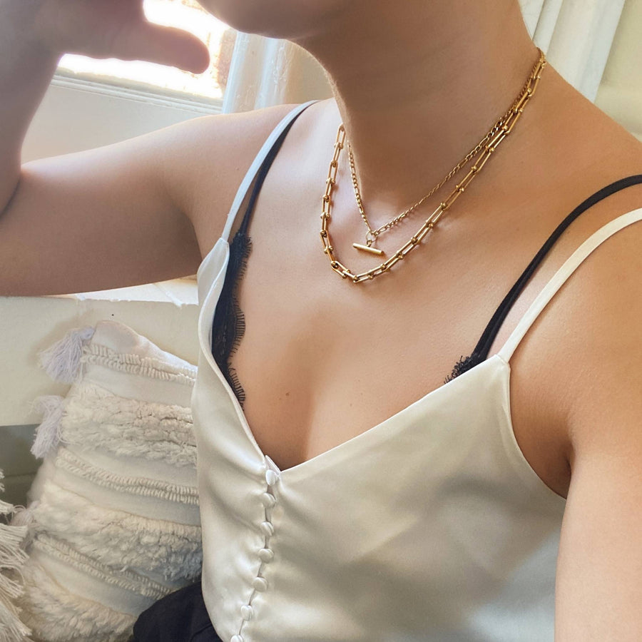 woman layering gold chains