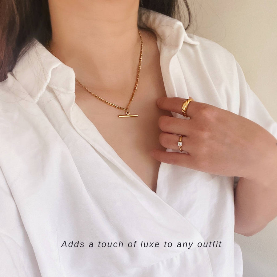 woman wearing fob necklace and white shirt